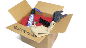 En papkasse mærket "Glemte Sager" med forskellige genstande.